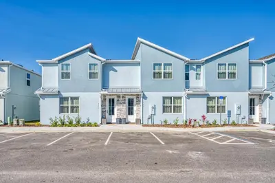 a large white house with a parking lot at Last Minute Disney Getaway Private Pool Themed Bedrooms. Book Now 95041 in Orlando