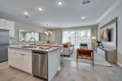 a kitchen with a sink and a living room at Last Minute Disney Getaway Private Pool Themed Bedrooms. Book Now 81943 in Orlando