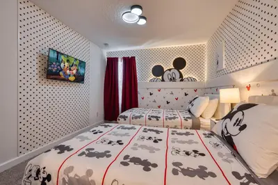 a bedroom with two beds and a wall with polka dots at Last Minute Disney Getaway Private Pool Themed Bedrooms. Book Now 81943 in Orlando