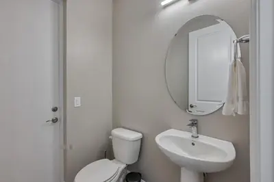 a bathroom with a toilet and a sink and a mirror at Last Minute Disney Getaway Private Pool Themed Bedrooms. Book Now 92789 in Orlando