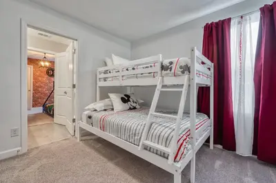 a bedroom with two bunk beds and red curtains at Last Minute Disney Getaway Private Pool Themed Bedrooms. Book Now 92789 in Orlando