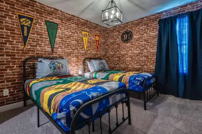 two beds in a room with a brick wall at Last Minute Disney Getaway! Private Pool, Hot Tub & Games Room. Book Now! #81939 in Orlando