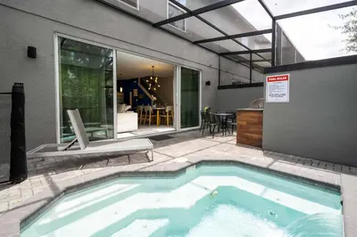 a swimming pool in the backyard of a house at Last Minute Disney Getaway Townhouse with Private Pool. Book Now 60511 in Kissimmee