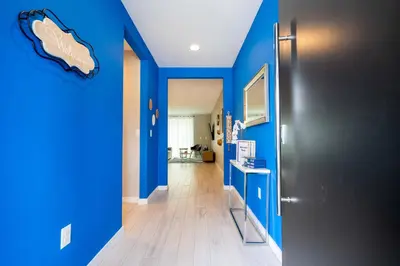 a hallway with blue walls and a black door at Last Minute Disney Getaway Townhouse with Private Pool. Book Now 60511 in Kissimmee