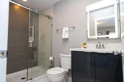 a bathroom with a shower and a toilet and a sink at Last Minute Disney Getaway Townhouse with Private Pool. Book Now 60511 in Kissimmee