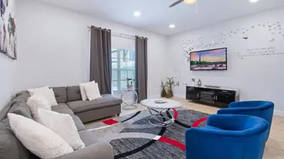 a living room with a couch and chairs and a tv at Last Minute Disney Getaway! Private Pool, Hot Tub & Games Room. Book Now! #56201 in Kissimmee