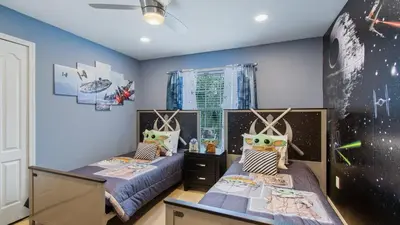two beds in a room with blue walls at Last Minute Disney Getaway! Private Pool, Hot Tub & Games Room. Book Now! #56201 in Kissimmee