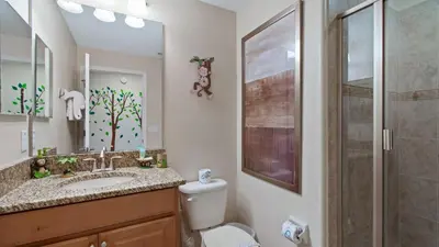 a bathroom with a toilet and a sink and a shower at Last Minute Disney Getaway! Private Pool, Hot Tub & Games Room. Book Now! #56201 in Kissimmee