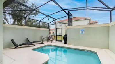 a swimming pool on a patio with a house at Last Minute Disney Getaway! Private Pool, Hot Tub & Games Room. Book Now! #56201 in Kissimmee