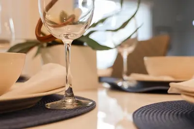 two wine glasses sitting on top of a table at Last Minute Disney Getaway Private Pool Themed Bedrooms. Book Now 93749 in Kissimmee