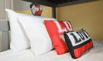 two pillows sitting on top of a bed at Last Minute Disney Getaway Private Pool Themed Bedrooms. Book Now 93749 in Kissimmee