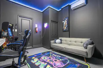a living room with a couch and a chair at Last Minute Disney Private Pool Hot Tub Themed Bedrooms. Book Now 93745 in Kissimmee