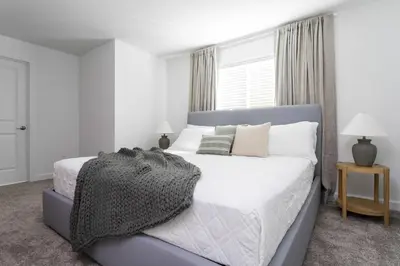 a bedroom with a bed with white sheets and pillows at Last Minute Disney Getaway Private Pool Themed Bedrooms. Book Now 99589 in Kissimmee