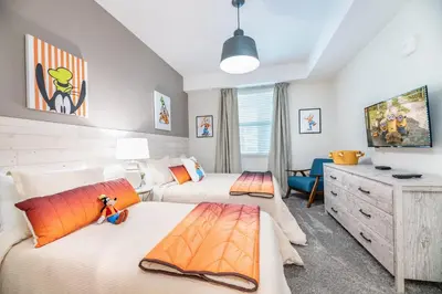 a bedroom with two beds and a tv at Storey Lake Resort 1053 - Hosted by Top Villas in Kissimmee