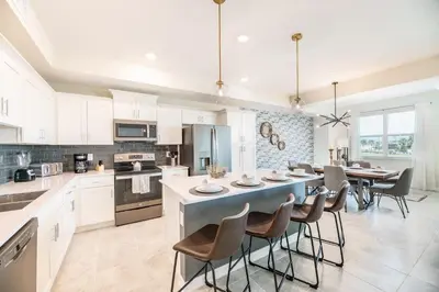 a kitchen and dining room with a table and chairs at Storey Lake Resort 1053 - Hosted by Top Villas in Kissimmee