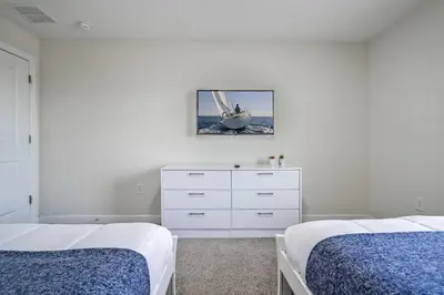 a white bedroom with two beds and a dresser at Storey Lake Resort 1071 - Hosted by Top Villas in Kissimmee