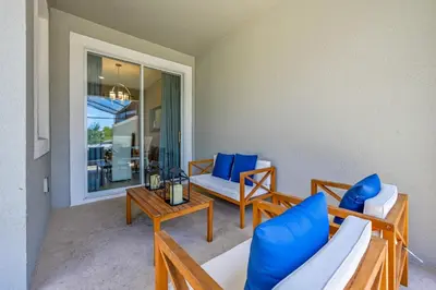 a living room with blue chairs and a table at Storey Lake Resort 1071 - Hosted by Top Villas in Kissimmee