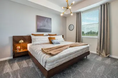 a bedroom with a large bed and a window at Storey Lake Resort 1081 - Hosted by Top Villas in Kissimmee