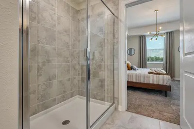 a master bathroom with a shower with a tub at Storey Lake Resort 1081 - Hosted by Top Villas in Kissimmee