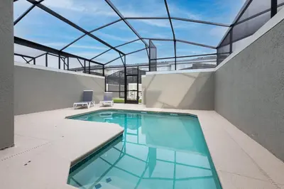an indoor swimming pool with a glass ceiling at Storey Lake Resort 1083 - Hosted by Top Villas in Kissimmee