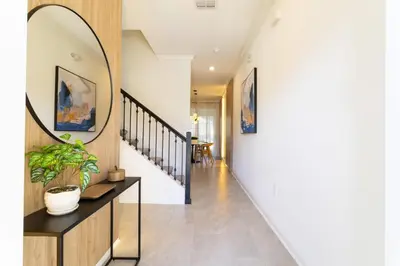 a hallway of a house with a mirror on the wall at Storey Lake Resort 1084 - Hosted by Top Villas in Kissimmee