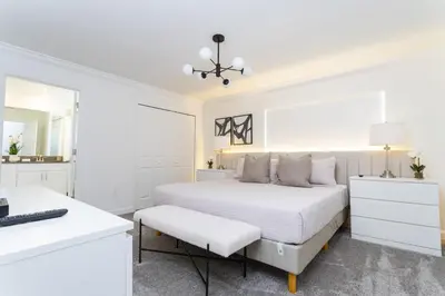 a white bedroom with a bed and a desk at Storey Lake Resort 1084 - Hosted by Top Villas in Kissimmee