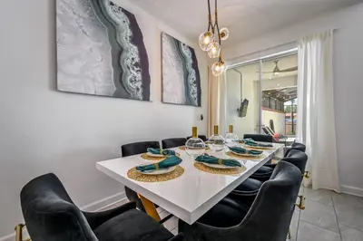 a dining room with a white table and black chairs at Storey Lake Resort 1085 - Hosted by Top Villas in Kissimmee