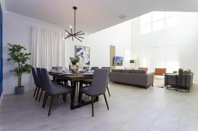 a dining room and living room with a table and chairs at Storey Lake Resort 1086 - Hosted by Top Villas in Kissimmee
