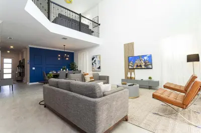 a living room with a gray couch and chairs at Storey Lake Resort 1086 - Hosted by Top Villas in Kissimmee