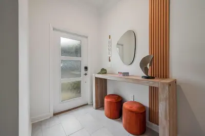 a bathroom with a vanity with a mirror and a stool at Storey Lake Resort 1088 - Hosted by Top Villas in Kissimmee