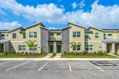 a large apartment building with a parking lot at Storey Lake Resort 1088 - Hosted by Top Villas in Kissimmee