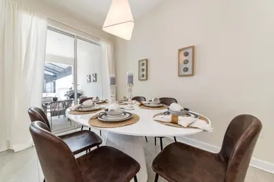 a dining room with a white table and chairs at Storey Lake Resort 1107 - Hosted by Top Villas in Kissimmee