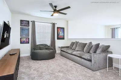 a living room with a couch and a ceiling fan at Storey Lake Resort 1110 - Hosted by Top Villas in Kissimmee