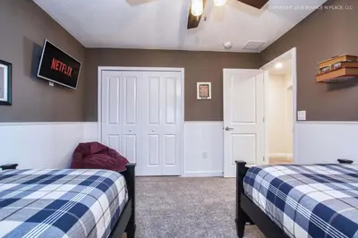 a bedroom with two beds and a exit sign on the wall at Storey Lake Resort 1110 - Hosted by Top Villas in Kissimmee