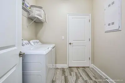 a small laundry room with a washer and dryer at Storey Lake Resort 1110 - Hosted by Top Villas in Kissimmee