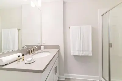 a white bathroom with a sink and a shower at Storey Lake Resort 1113 - Hosted by Top Villas in Kissimmee