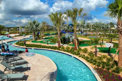 a pool at a resort with chairs and palm trees at Storey Lake Resort 1113 - Hosted by Top Villas in Kissimmee