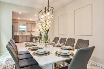 a dining room with a white table and chairs at Last Minute Disney Private Pool Hot Tub Game Room Themed Bedrooms. Book Now 32850 in Kissimmee
