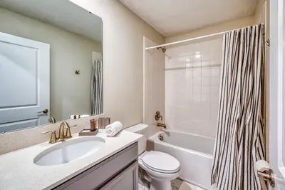 a bathroom with a sink and a toilet and a tub at Last Minute Disney Private Pool Hot Tub Game Room Themed Bedrooms. Book Now 32850 in Kissimmee
