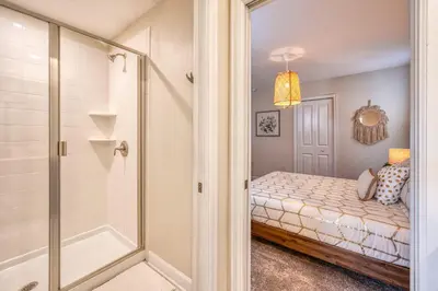 a small bedroom with a shower and a bed at Last Minute Disney Private Pool Hot Tub Game Room Themed Bedrooms. Book Now 32850 in Kissimmee