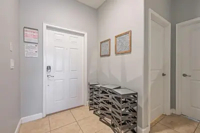 a room with white walls and a staircase with wine racks at Last Minute Disney Getaway Townhouse with Private Pool. Book Now 17222 in Kissimmee