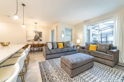 a living room with couches and a dining room at Last Minute Disney Getaway Private Pool Themed Bedrooms. Book Now 98613 in Kissimmee