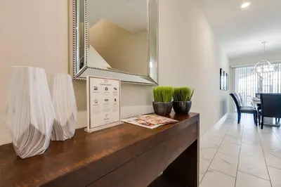 a living room with a table with a mirror at Last Minute Disney Getaway Private Pool Themed Bedrooms. Book Now 17254 in Kissimmee