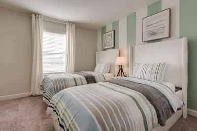 two beds in a bedroom with green and white walls at Last Minute Disney Getaway Private Pool Themed Bedrooms. Book Now 17254 in Kissimmee