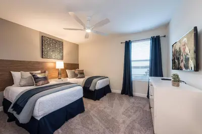 a bedroom with two beds and a ceiling fan at Storey Lake Resort 61 - Hosted by Top Villas in Kissimmee