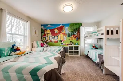 a bedroom with two beds and a mural of a house at Last Minute Disney Private Pool Hot Tub Themed Bedrooms. Book Now 17198 in Kissimmee