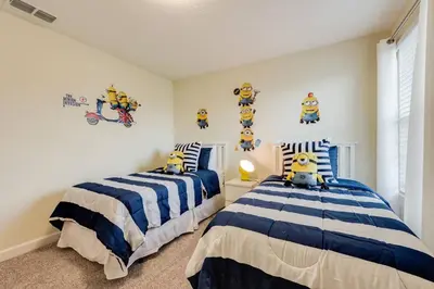 two beds in a bedroom with blue and white at Last Minute Disney Private Pool Hot Tub Themed Bedrooms. Book Now 17198 in Kissimmee