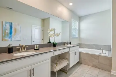 a bathroom with two sinks and a bath tub at Last Minute Disney Private Pool Hot Tub Themed Bedrooms. Book Now 54267 in Kissimmee