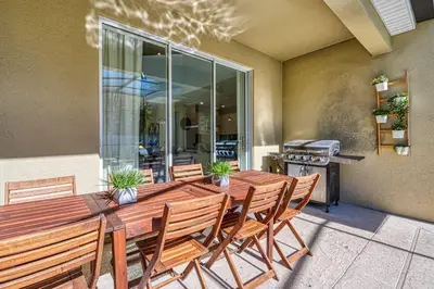 a wooden table with chairs and a grill at Last Minute Disney Private Pool Hot Tub Themed Bedrooms. Book Now 54267 in Kissimmee