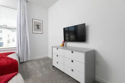 a white dresser with a television on top of it at Last Minute Disney Private Pool Hot Tub Themed Bedrooms. Book Now 56873 in Kissimmee
